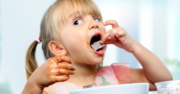 little kid eating chocolates